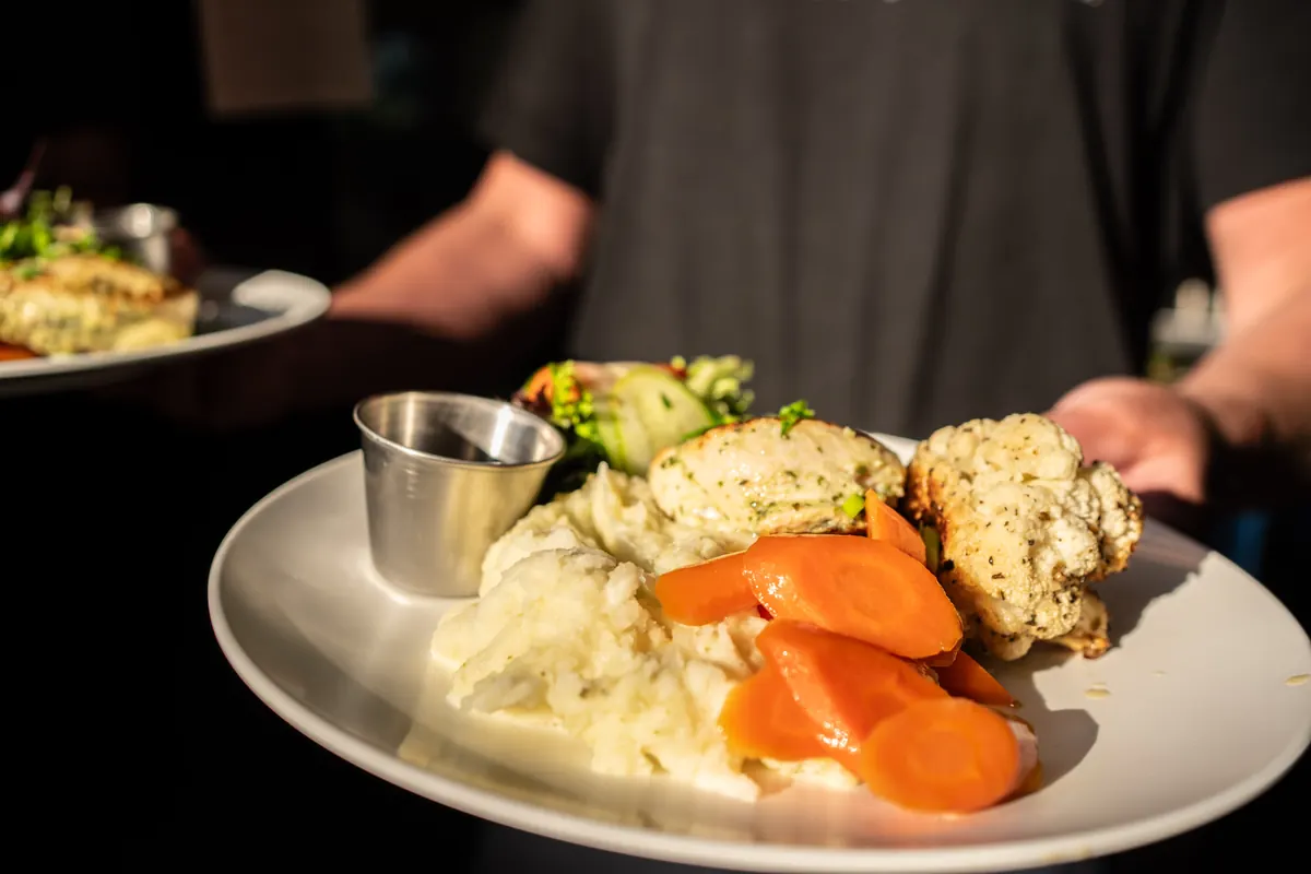 A plated dinner sits on a table at Orca Camp.