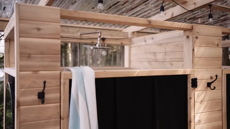 A towel hangs ready in the open-air shower.